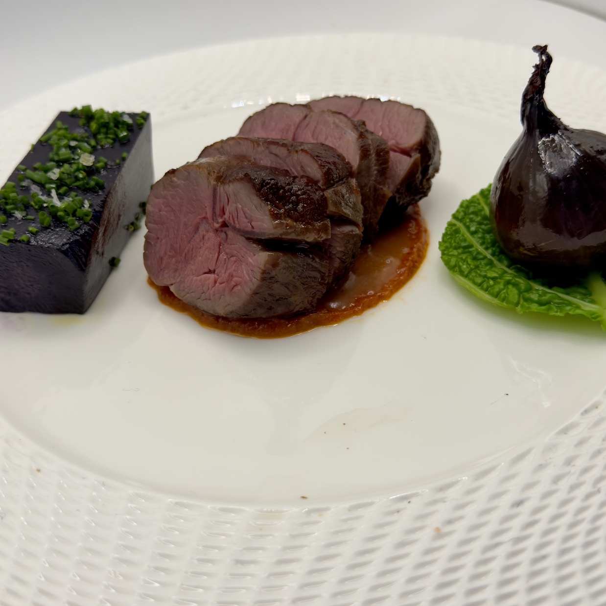 Sliced venison loin with fig and herb crust