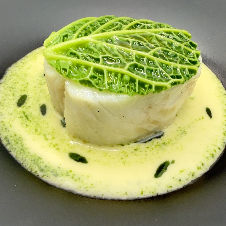 Cabbage-wrapped fish in herb velouté
